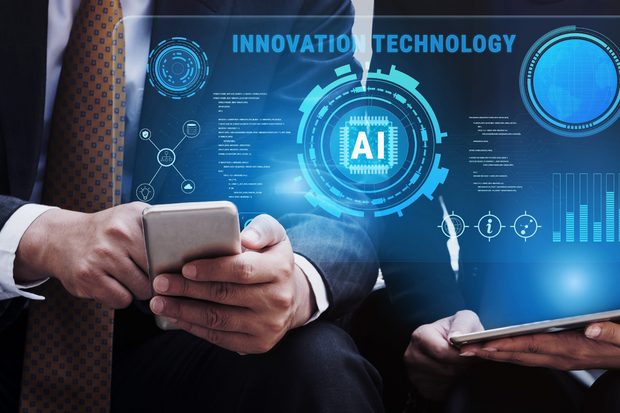Businessperson in a suit holding a phone in front of a glowing blue holographic dashboard labeled Innovation Technology, centered on an AI chip graphic.