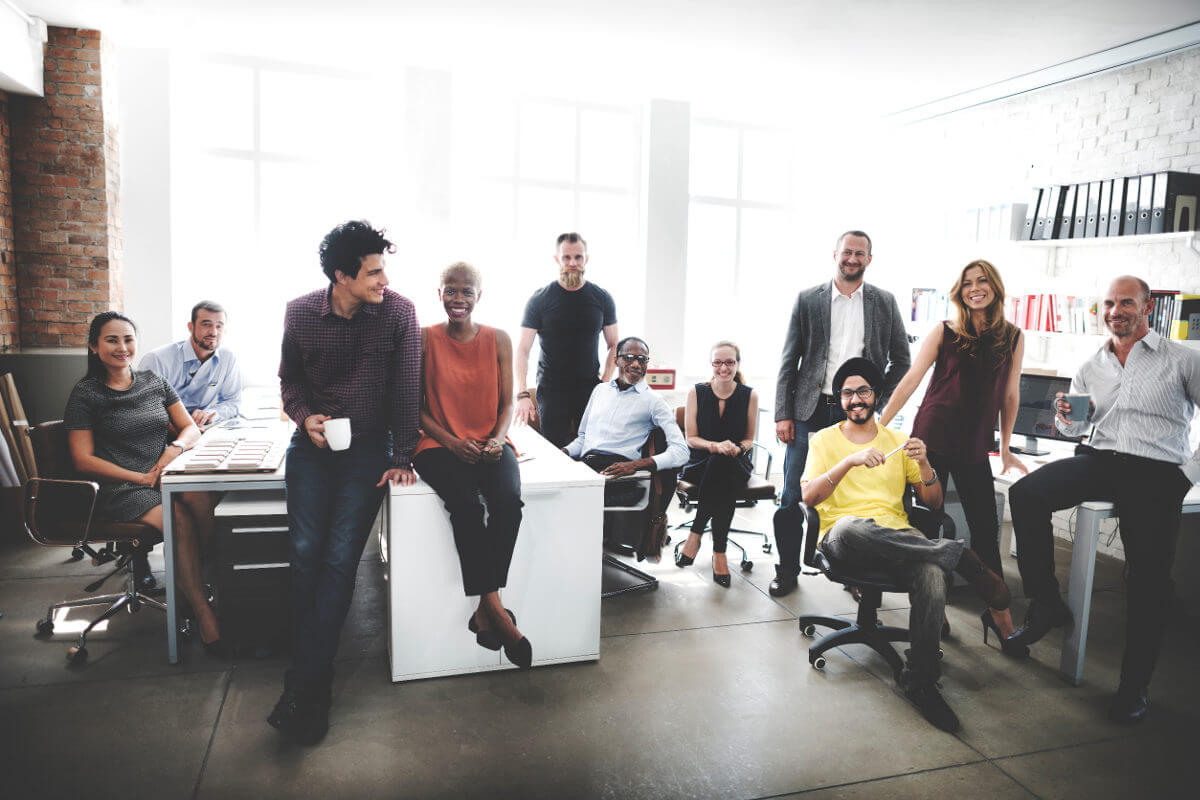 Business office full of smiling young profesionals