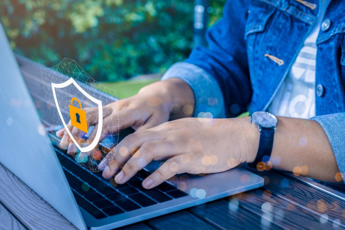 Working on laptop - cybersecurity concept.