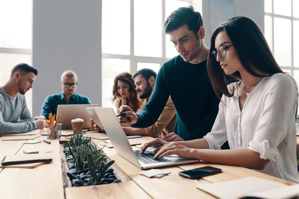 Businessmen helping younger colleagues