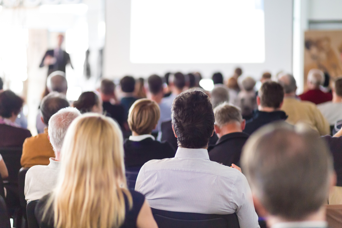 A backshot of the heads of people attending a business seminar