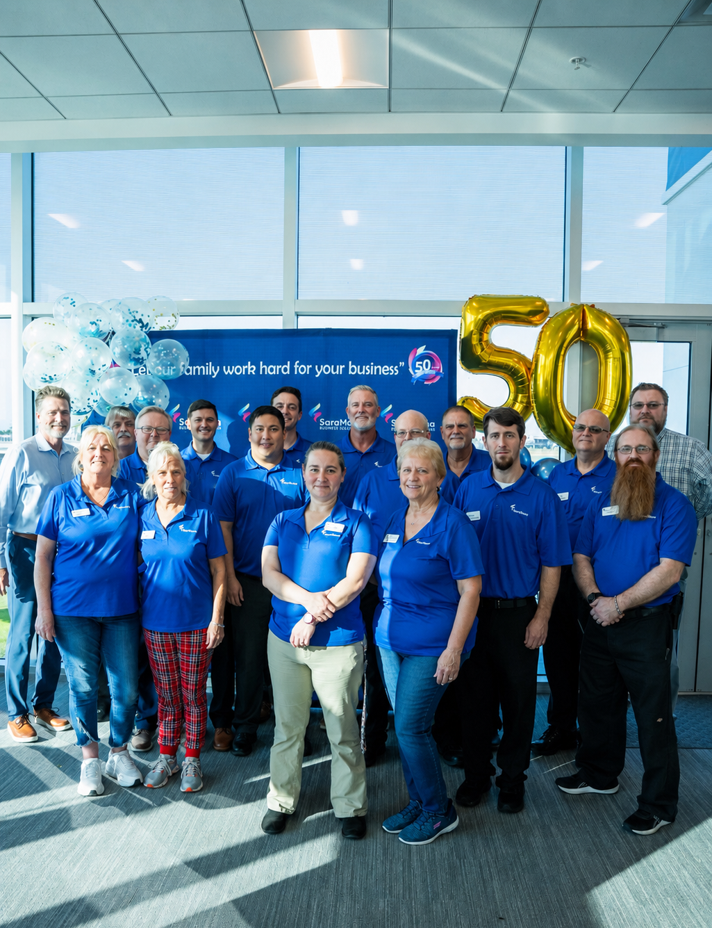 SaraMana team of business technology professionals standing together, proudly serving Florida businesses since 1976.