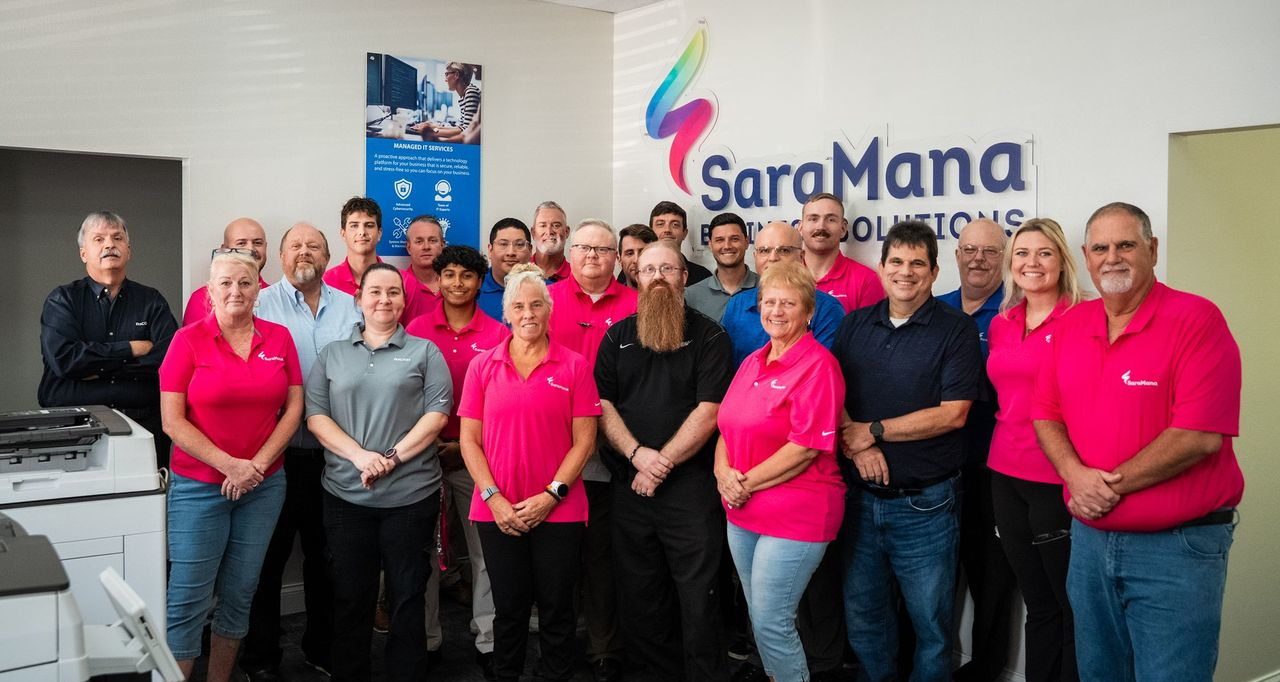 SaraMana team of business technology professionals standing together, proudly serving Florida businesses since 1976.